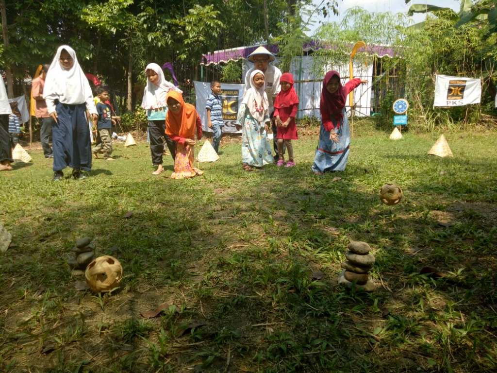 anak-anak bermain lempar batu dengan bola takraw